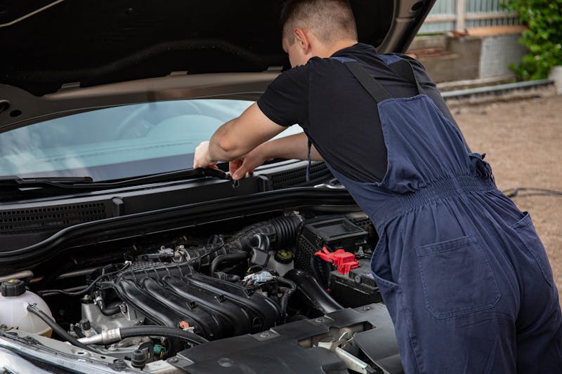 Mechanic working under the hood of a car
