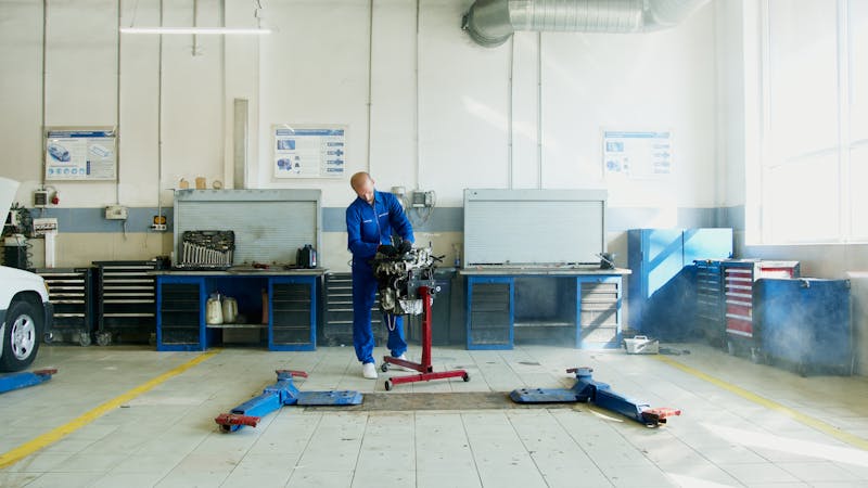 Mobile mechanic inspecting a car engine