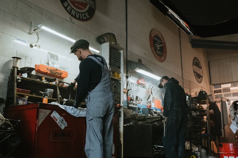 Professional mechanics working together on a vehicle